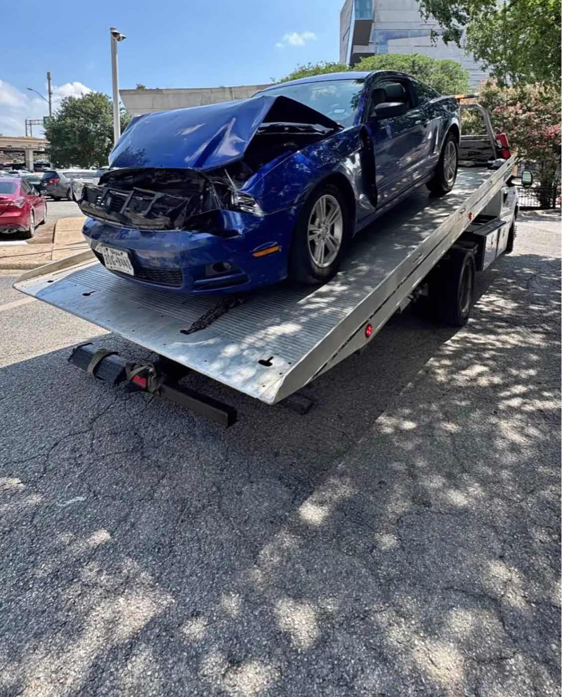 Wrecked sports car on the flatbed